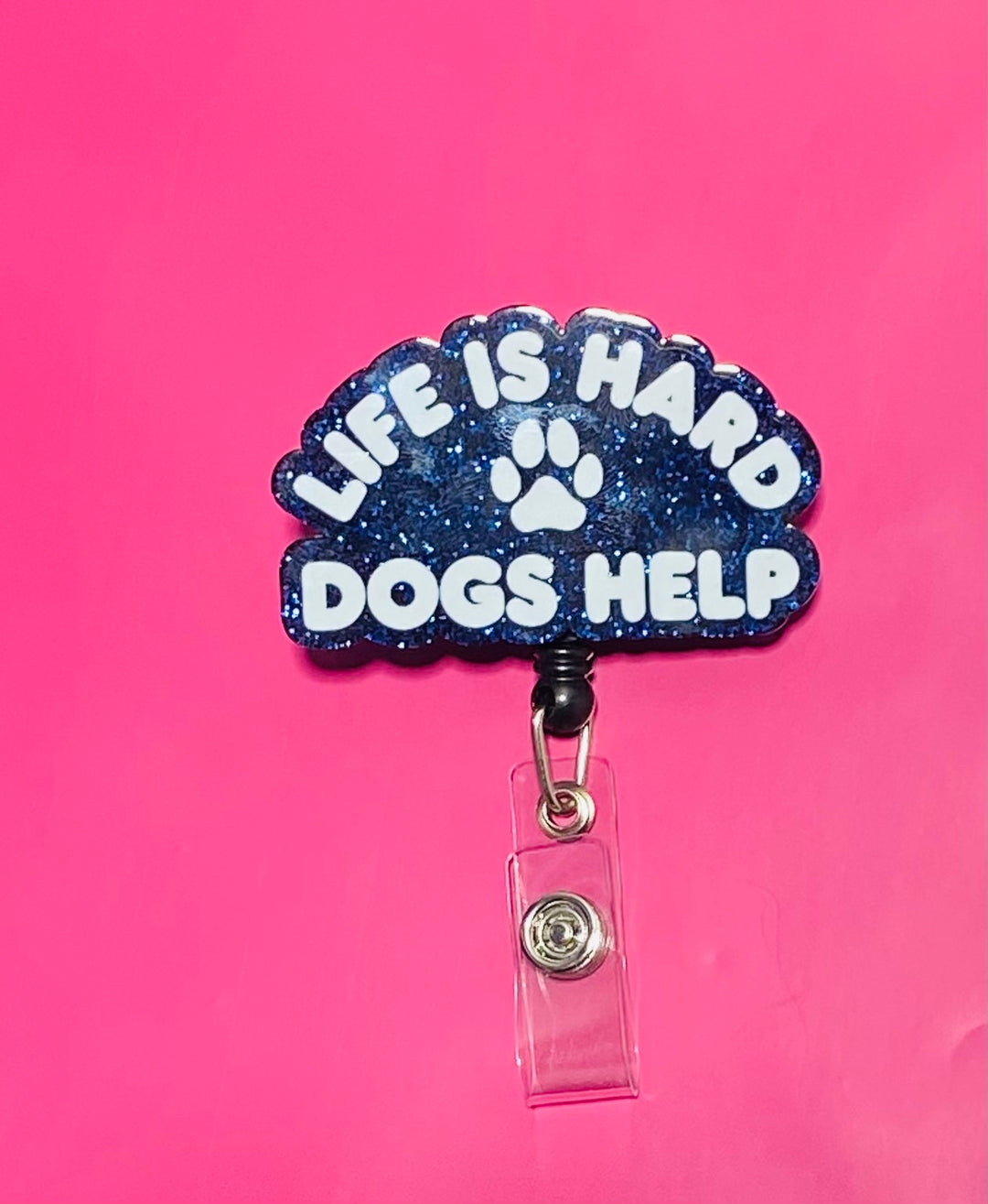 Badge holder with 'Life is Hard, Dogs Help' text on a pink background