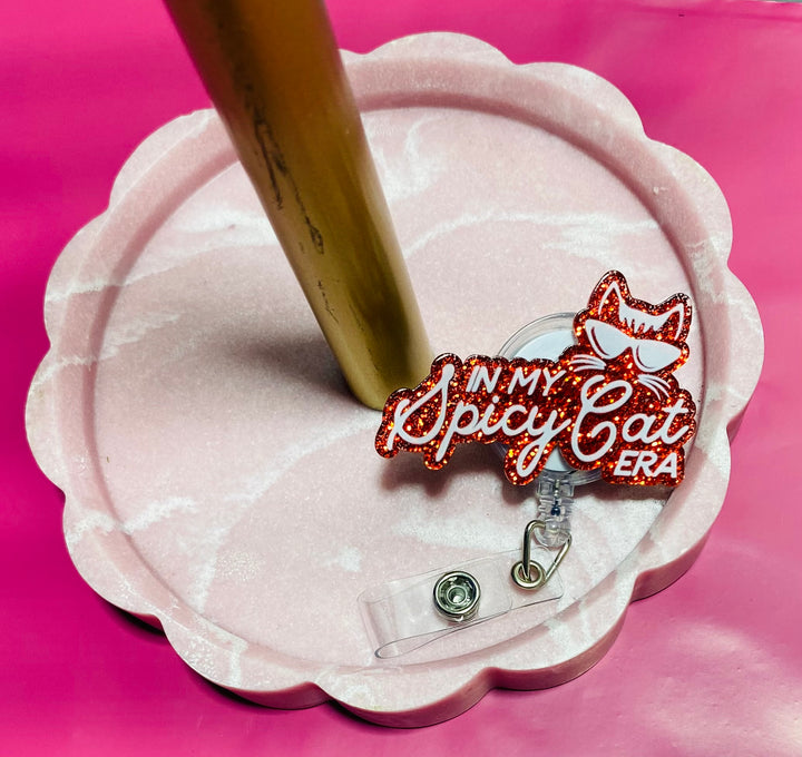 Badge holder with 'In My Spicy Cat Era' design on a pink background