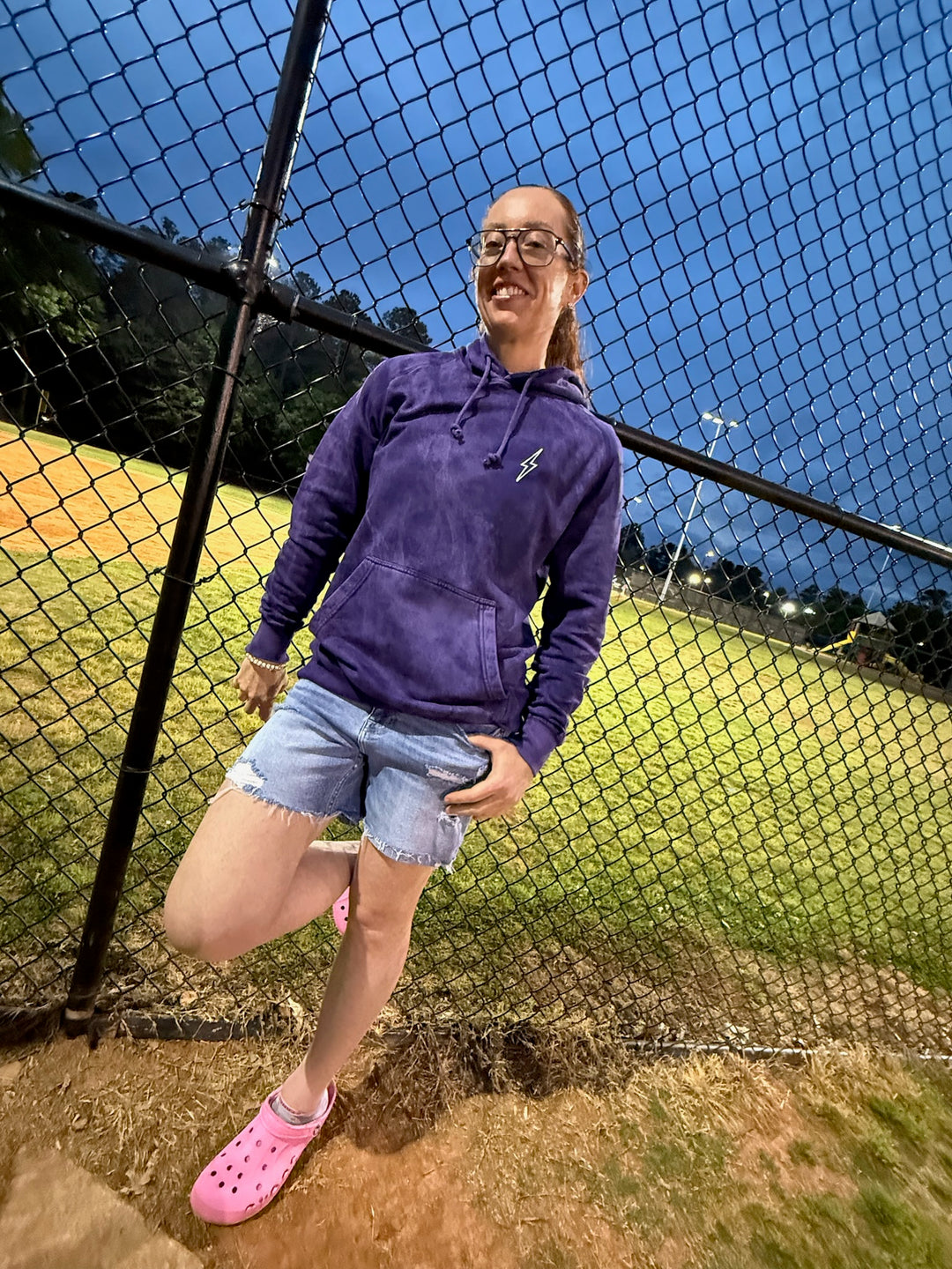 Dr. Betsy Grunch (Ladyspinedoc) wearing the purple Incredible Hoodie, displaying the front of the shirt with lightning bolt on chest. 