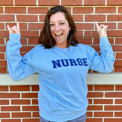 Dr. Betsy Grunch's nurse, Kandi Hulsey,  wearing a size medium of the All Oopsies No Daisies Nurse Sweatshirt.