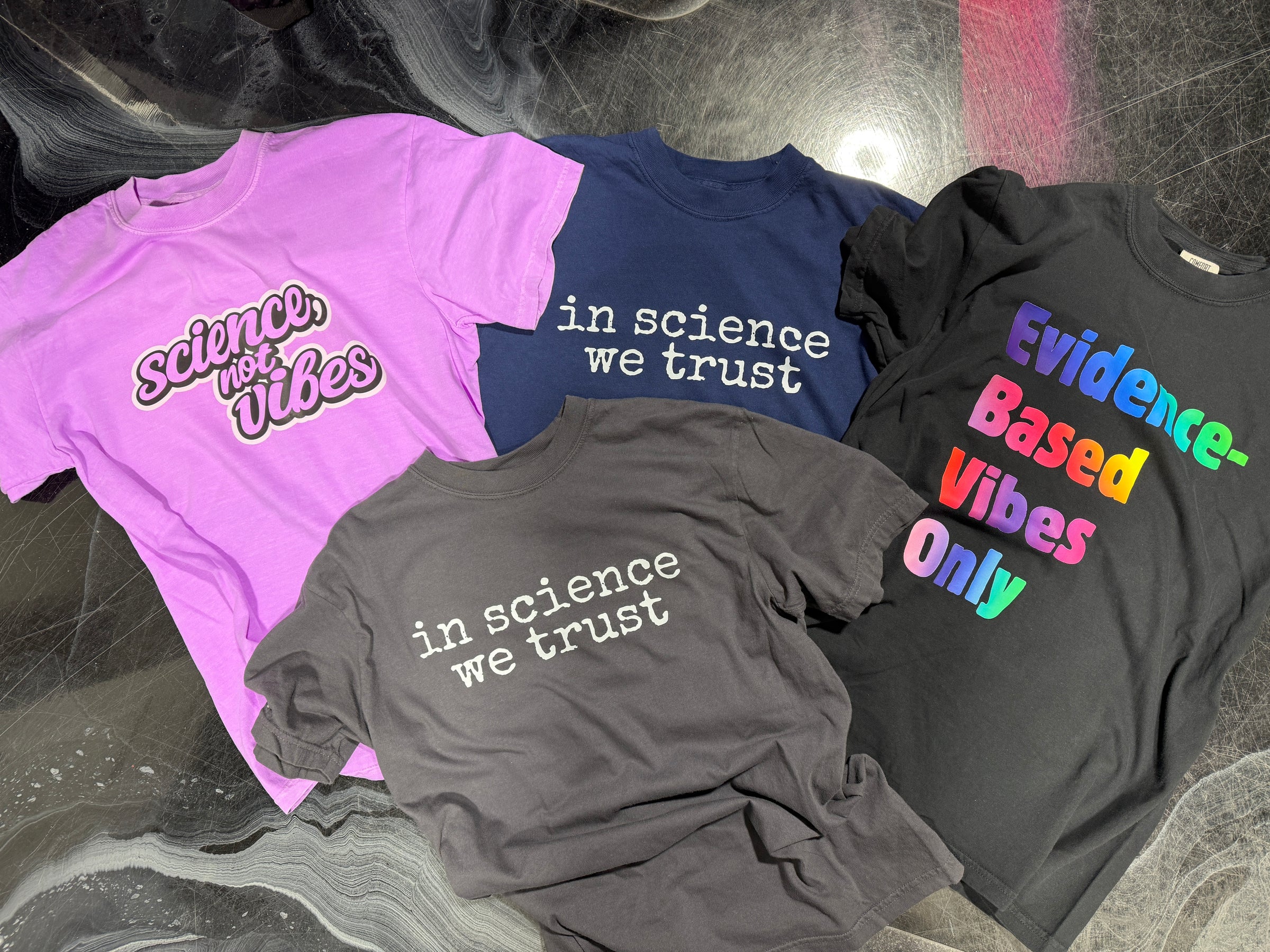 four shirts with a science theme