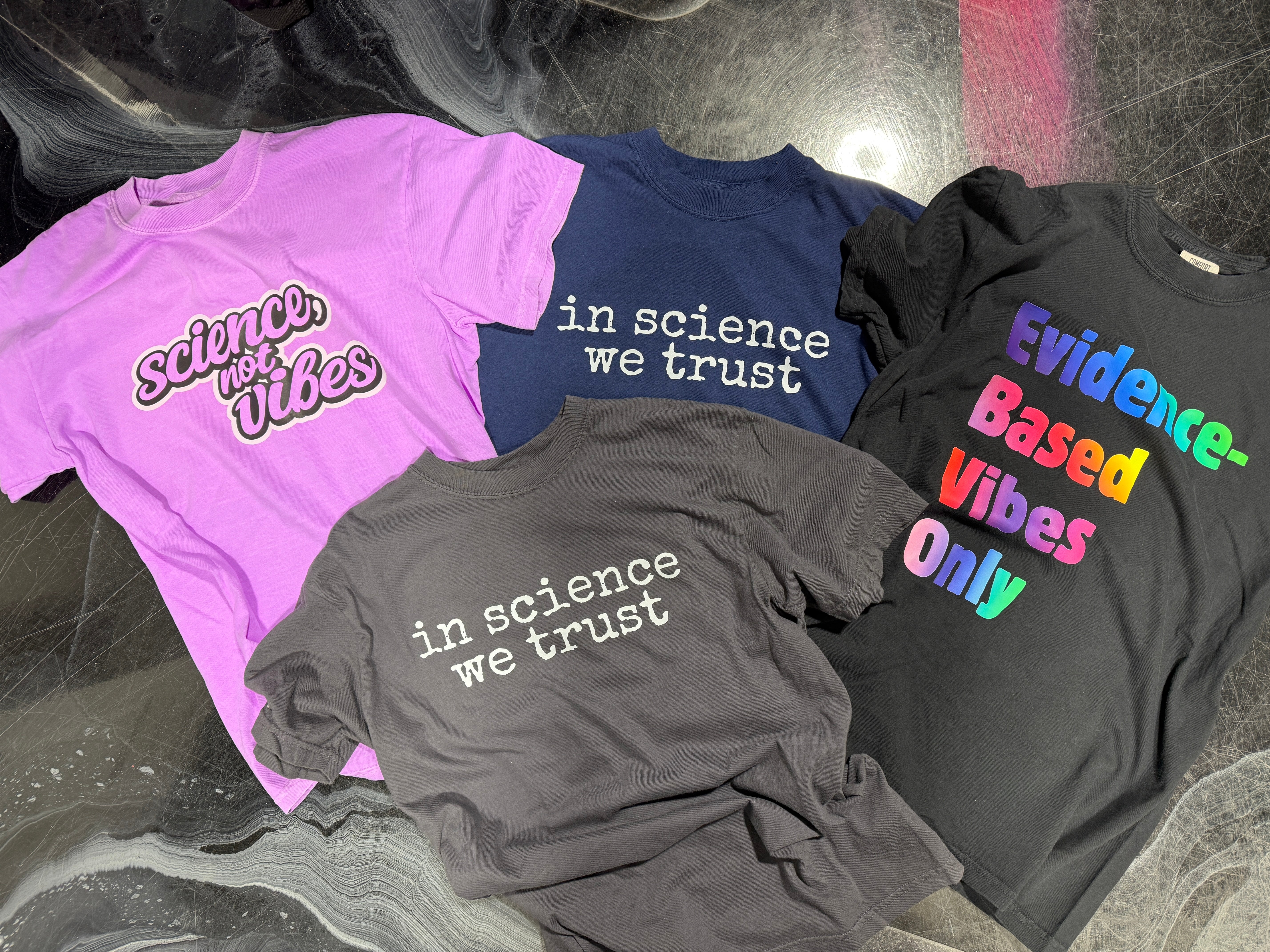 four shirts with a science theme
