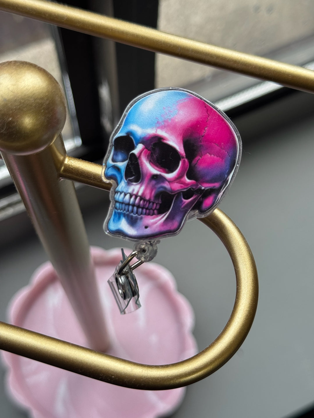 Super Skull Badge Reel clipped on gold rack