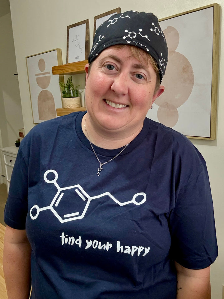 Smiling Dr. Beachgem wearing navy Dopamine Rush tee with Dopamine Molecule Design and "Find Your Happy" Motto