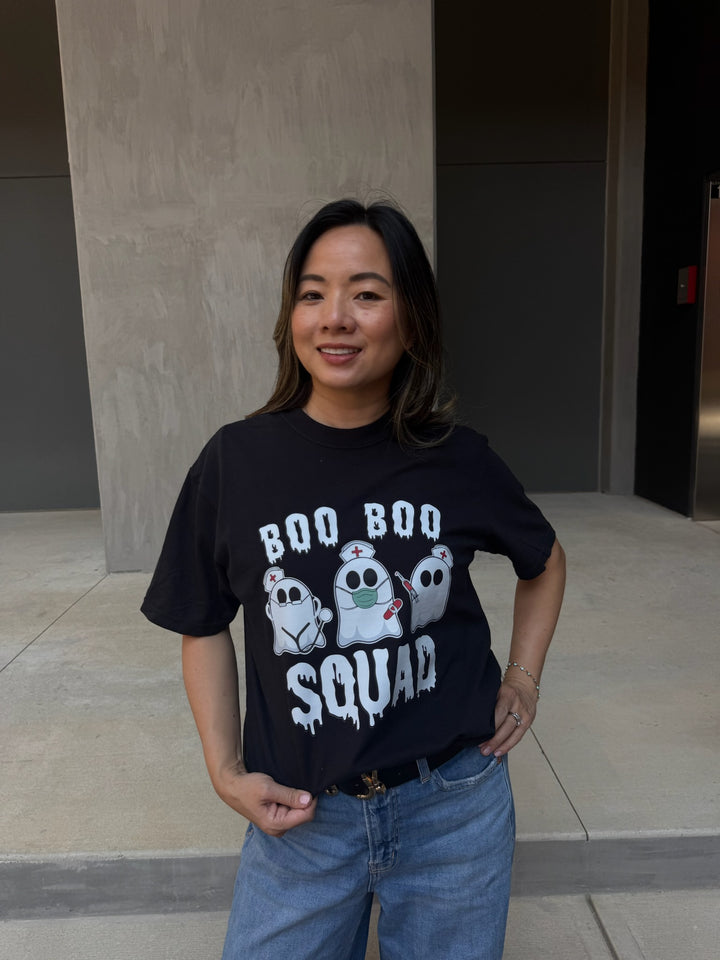 Model showing off front of Ladyspinedoc x Dr. Beachgem Collab: Boo Boo Squad Tee Shirt – Halloween Shirt for Healthcare Heroes with ghost nurses