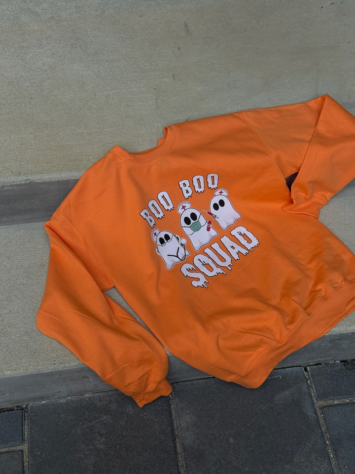 Flat lay of the Ladyspinedoc x Dr. Beachgem Collab: Boo Boo Squad Crewneck Sweatshirt – Halloween Shirt for Healthcare Heroes
