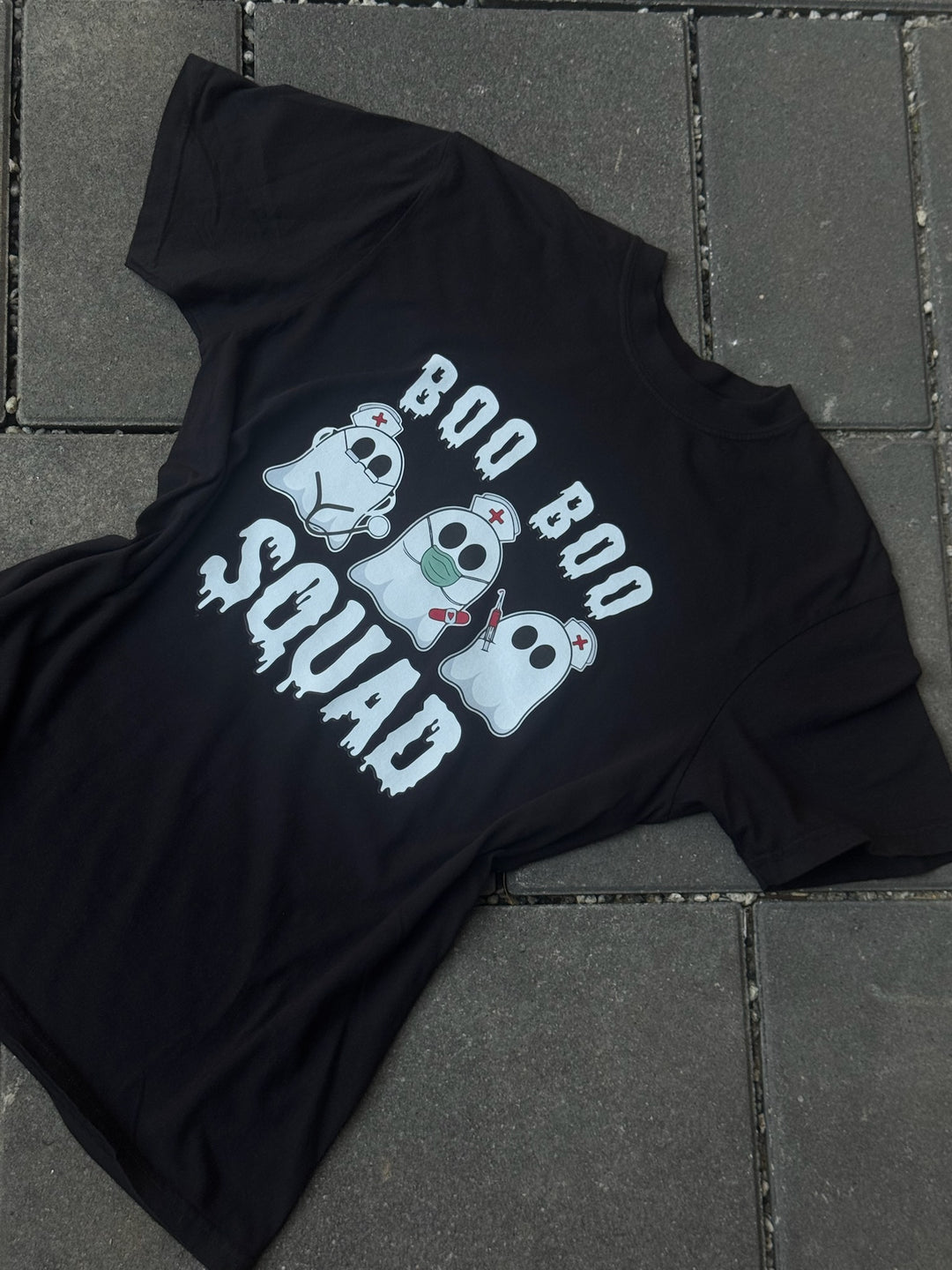 Flat lay of Ladyspinedoc x Dr. Beachgem Collab: Boo Boo Squad Tee Shirt – Halloween Shirt for Healthcare Heroes