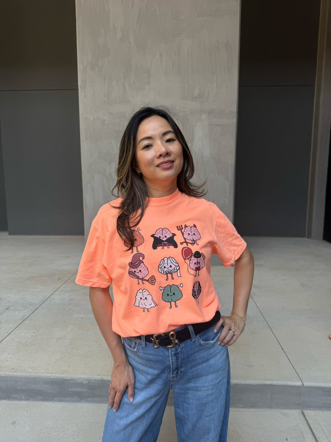 Model wearing Halloween Brains Tee Shirt with Cartoon Brain Characters: Pumpkin, Ghost, Witch, Vampire, Mummy & More