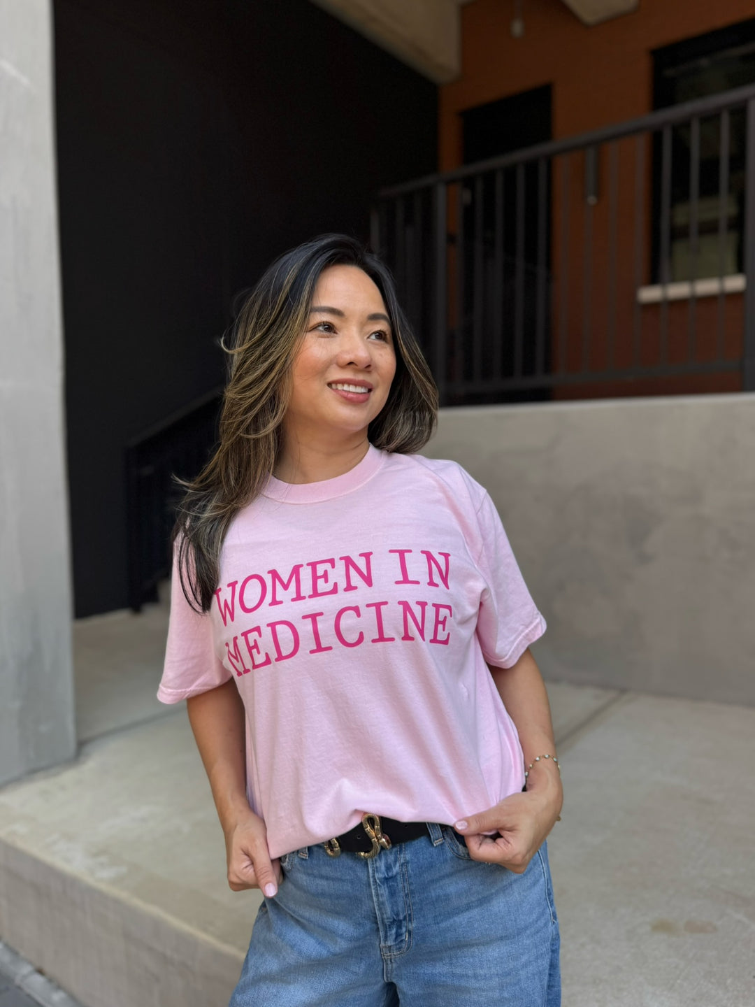 Model wearing pink Women in Medicine Tee Shirt - Empowering Short Sleeve T-Shirt for Healthcare Pros