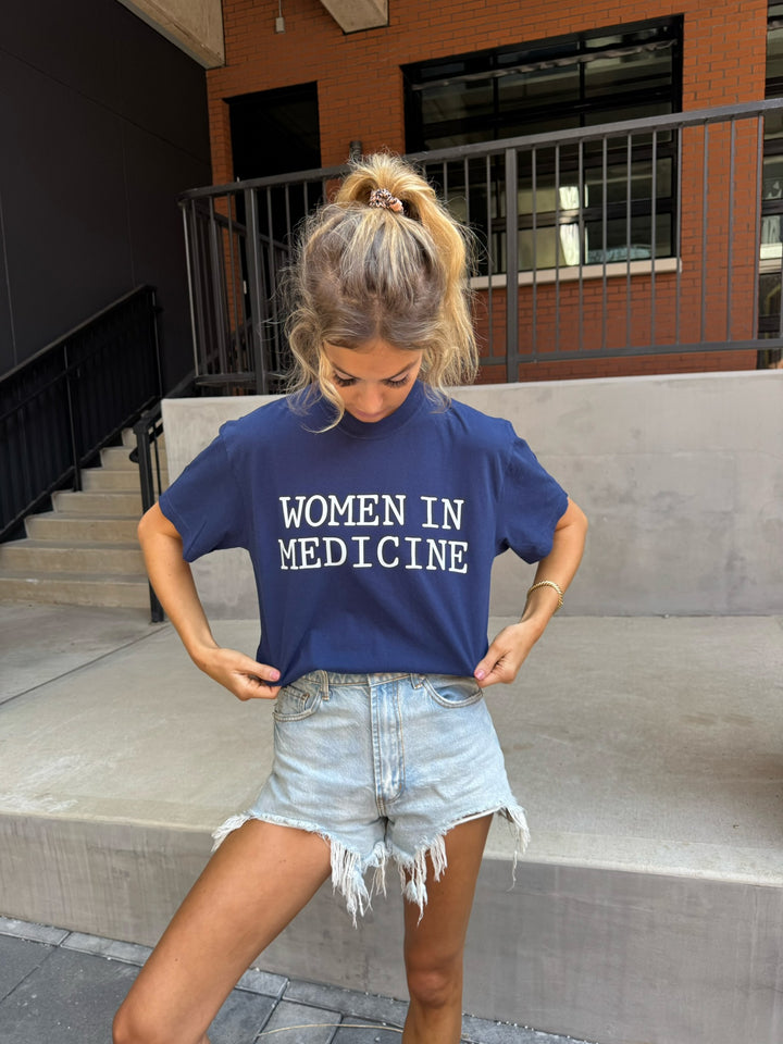 Model wearing blue Women in Medicine Tee Shirt - Empowering Short Sleeve T-Shirt for Healthcare Pros
