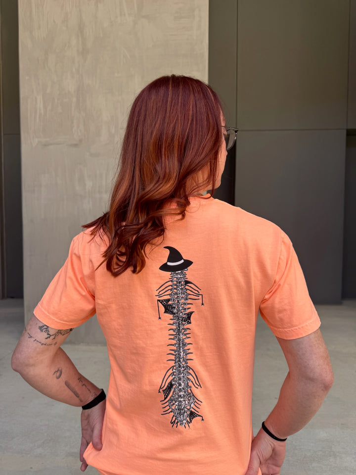 Ladyspinedoc wearing Halloween Spooky Spine - Orange Short Sleeve Tee Shirt and showing off the back spinal design