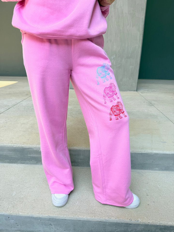 Model wearing Chan Art Collab: Game Day Set, showing sweatpants with blue, pink and red bulldogs