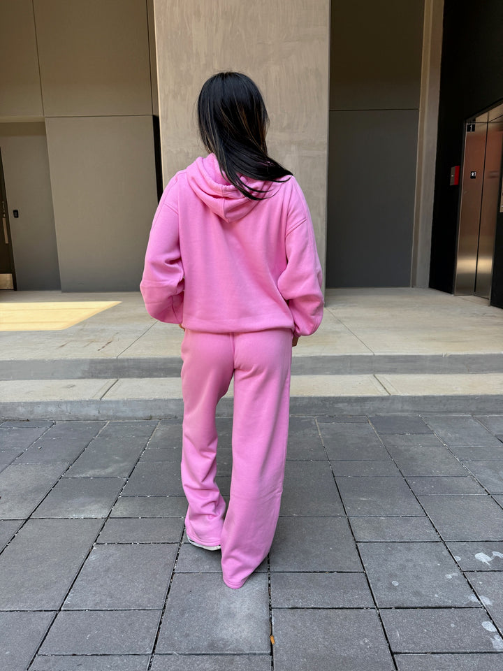 Model showing off the back of the Chan Art Collab: Game Day Set - Pink Hoodie & Sweatpants