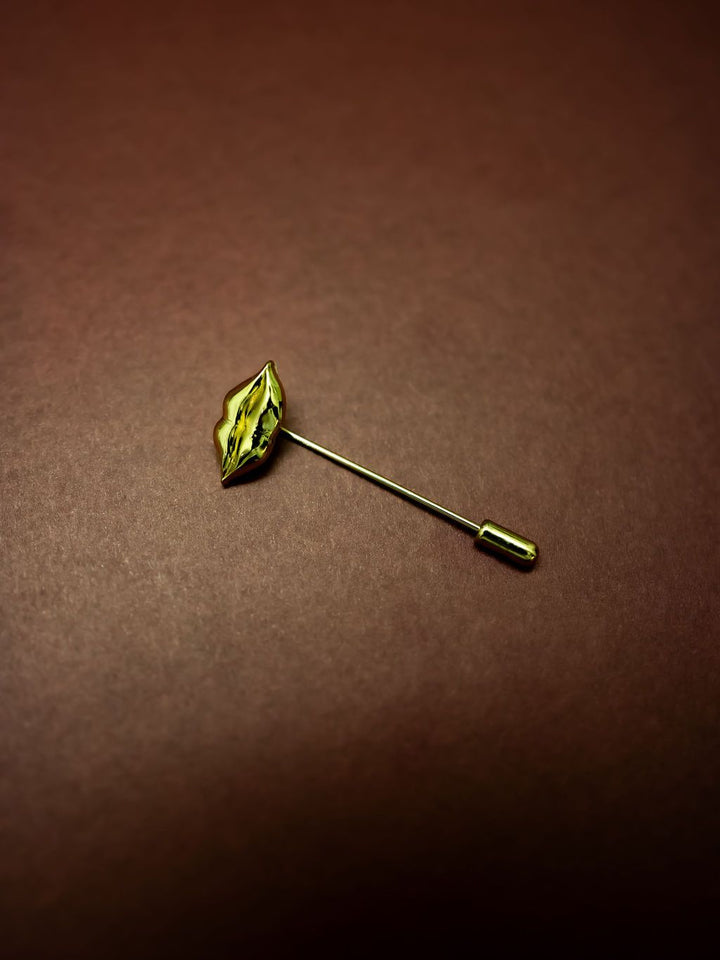 Lips Stick Pin in gold on a burgundy background