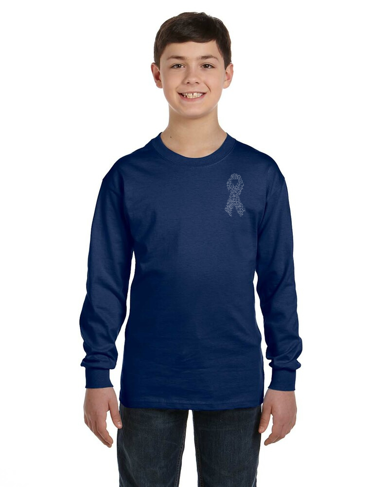 Child wearing a navy blue long-sleeve diabetes awareness shirt with a ribbon design (made up of insulin molecules) on a white background